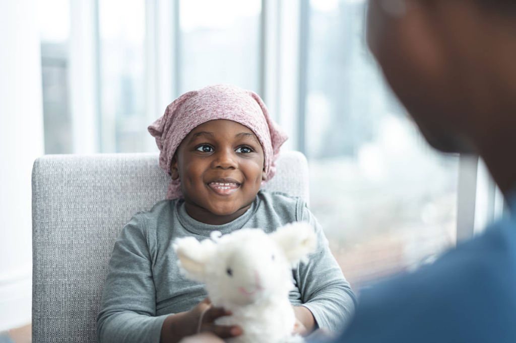Girl holding a white stuffed animal in an office